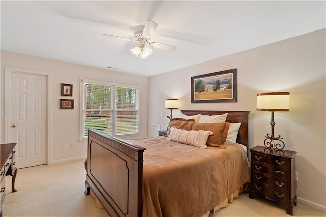 bedroom with light colored carpet, baseboards, ceiling fan, and visible vents