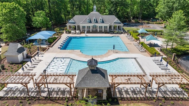 pool with fence, a pergola, and a patio area