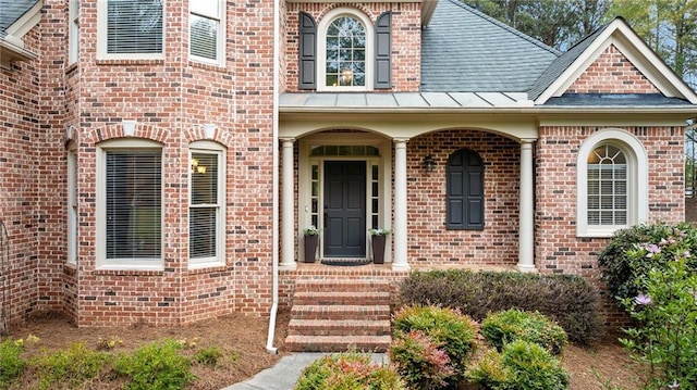 doorway to property featuring brick siding