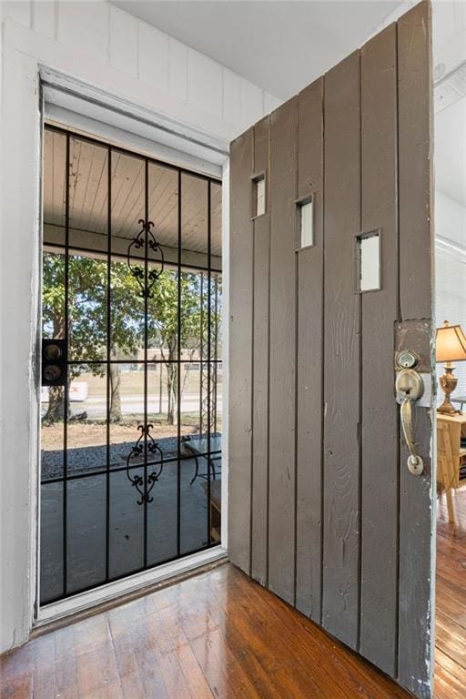 doorway with hardwood / wood-style flooring