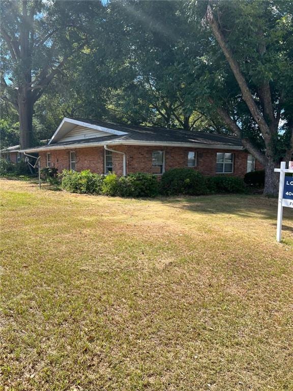 view of home's exterior with a lawn