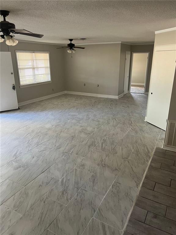 spare room featuring ceiling fan and a textured ceiling