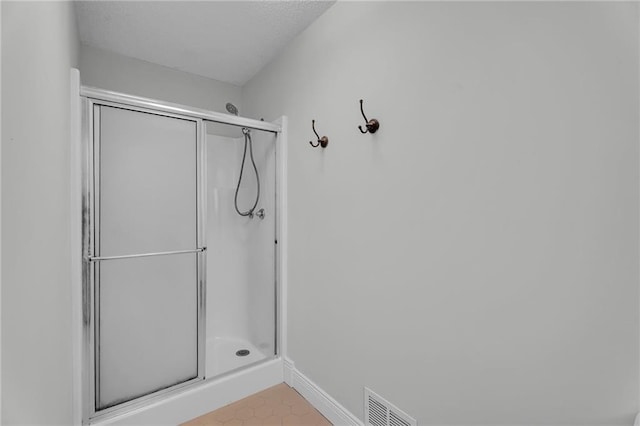 bathroom with a shower with shower door