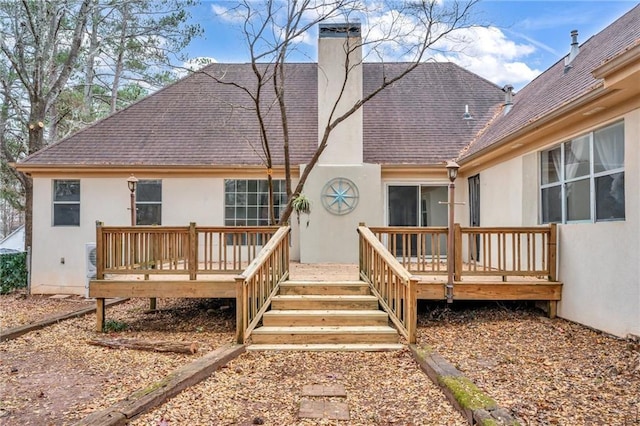 back of house featuring a wooden deck