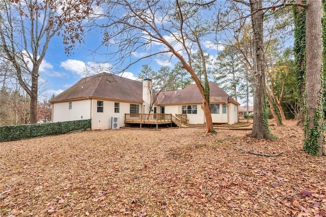 back of property featuring a wooden deck