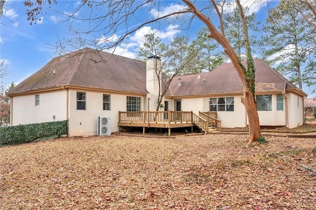 back of property with ac unit and a deck