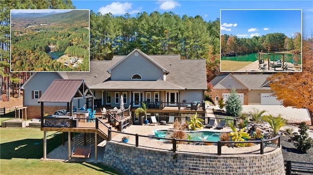 back of property with fence, a yard, a wooden deck, an outdoor pool, and a patio area