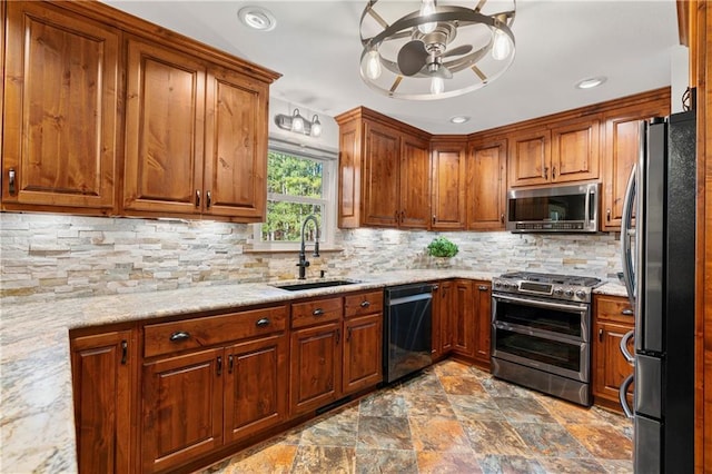 kitchen featuring appliances with stainless steel finishes, brown cabinetry, a sink, and tasteful backsplash