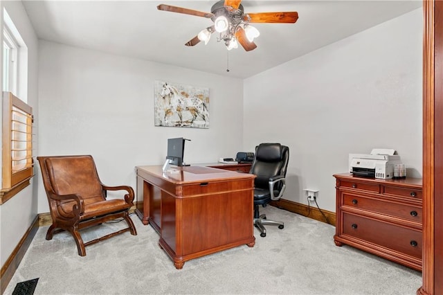 office with a ceiling fan, light carpet, visible vents, and baseboards