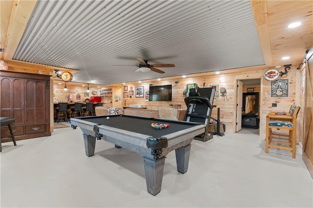 playroom with concrete flooring, recessed lighting, wooden walls, pool table, and bar