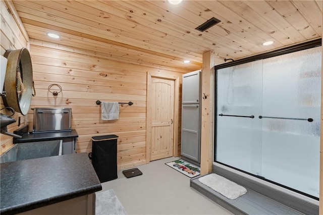 interior space with wood ceiling, finished concrete floors, and visible vents