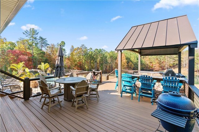 deck with grilling area, outdoor dining area, and a gazebo