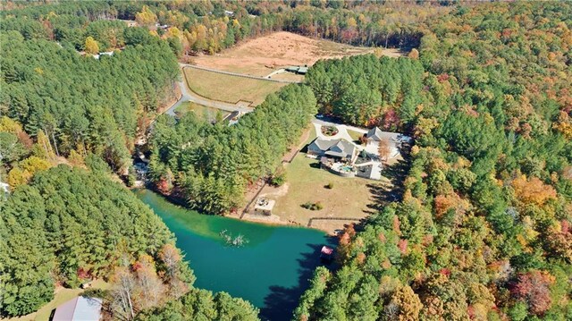 birds eye view of property with a water view and a forest view