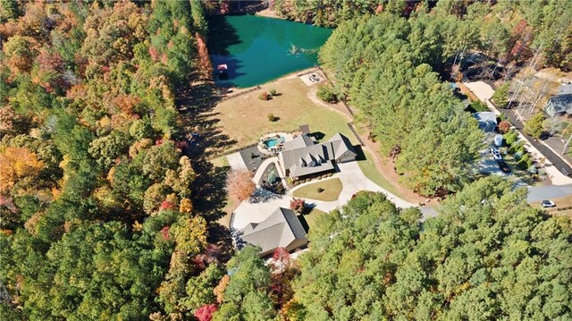 birds eye view of property featuring a water view and a forest view