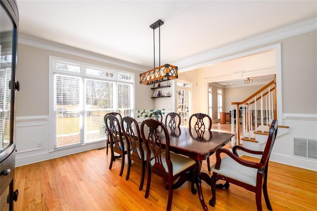 1105 River Laurel Dr, Suwanee, GA 30024 - dining area with ornamental molding, light wood-type flooring, plenty of natural light, and stairs