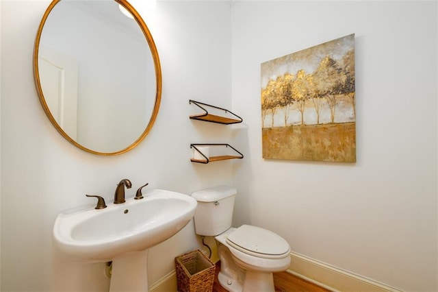 1105 River Laurel Dr, Suwanee, GA 30024 - half bathroom featuring toilet, baseboards, and a sink