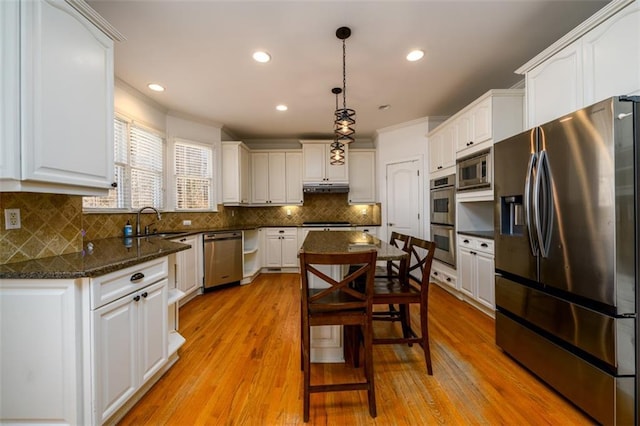 1105 River Laurel Dr, Suwanee, GA 30024 - kitchen featuring appliances with stainless steel finishes, under cabinet range hood, white cabinets, and recessed lighting