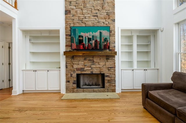 1105 River Laurel Dr, Suwanee, GA 30024 - living room with a stone fireplace, built in shelves, and wood finished floors