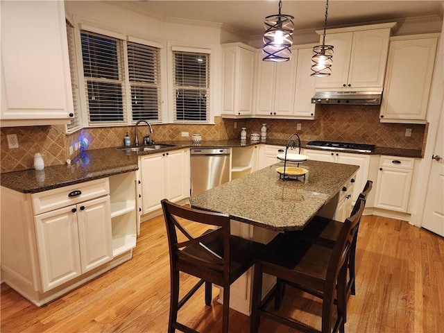 1105 River Laurel Dr, Suwanee, GA 30024 - kitchen featuring a sink, under cabinet range hood, light wood-type flooring, decorative backsplash, and crown molding