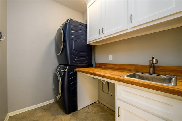 1105 River Laurel Dr, Suwanee, GA 30024 - washroom featuring estacked washer and dryer, cabinet space, light tile patterned floors, and baseboards
