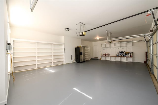 1105 River Laurel Dr, Suwanee, GA 30024 - garage featuring stainless steel fridge with ice dispenser and a garage door opener