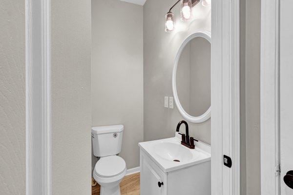 583 Whitaker St, Atlanta, GA 30318 - half bathroom featuring vanity and wood finished floors