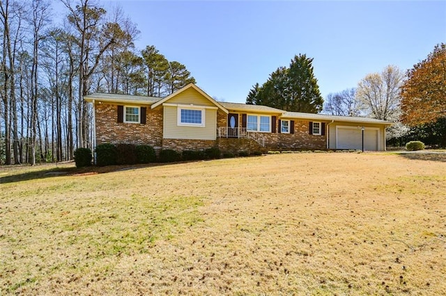 ranch-style home featuring a front yard, an attached garage, brick siding, and driveway