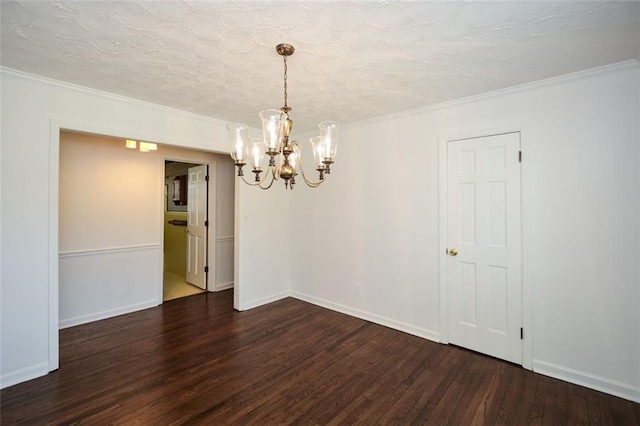 empty room with dark wood-type flooring, ornamental molding, baseboards, and a textured ceiling