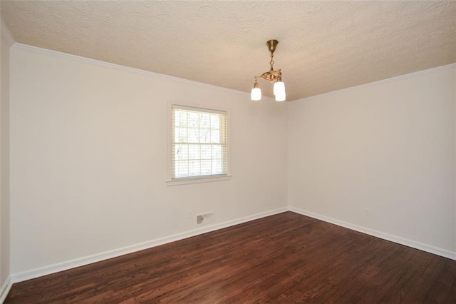 empty room with baseboards, dark wood-type flooring, ornamental molding, and a textured ceiling