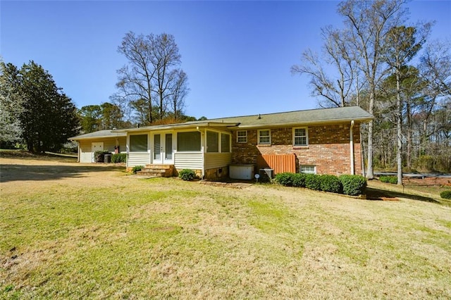 view of front of property with a front lawn and brick siding