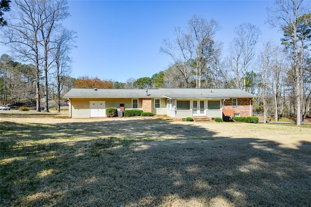 single story home featuring entry steps, french doors, and a front yard