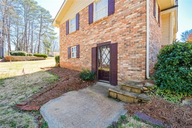 view of exterior entry with brick siding