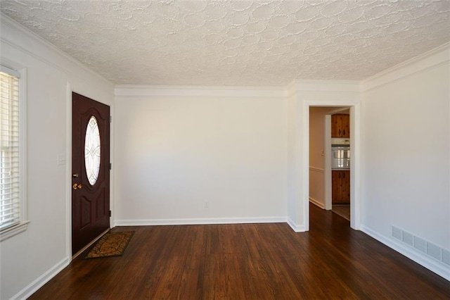 foyer with visible vents, a textured ceiling, baseboards, and wood finished floors