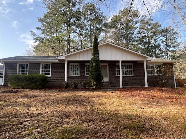 ranch-style home with a porch and brick siding