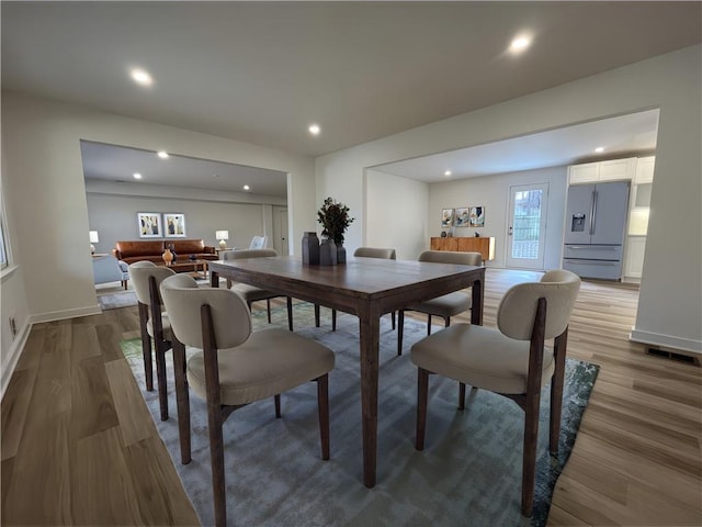 dining room with visible vents, recessed lighting, baseboards, and wood finished floors