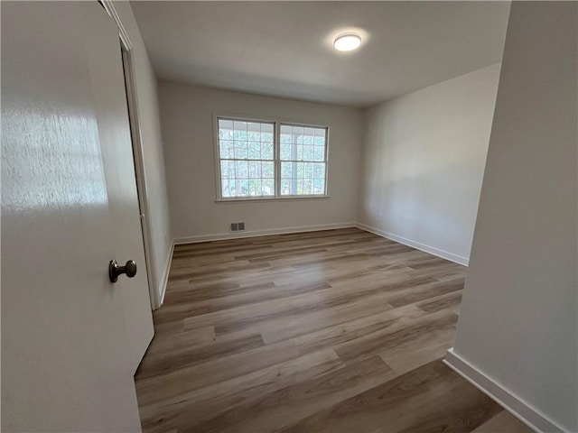 spare room with light hardwood / wood-style flooring