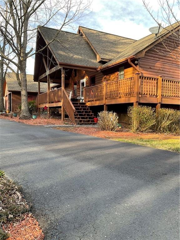 view of front of property featuring roof with shingles