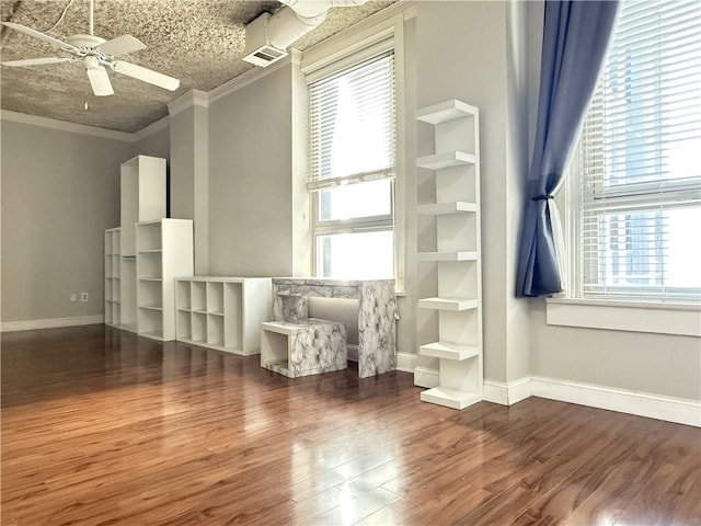 unfurnished room with hardwood / wood-style floors, a textured ceiling, a healthy amount of sunlight, and ceiling fan