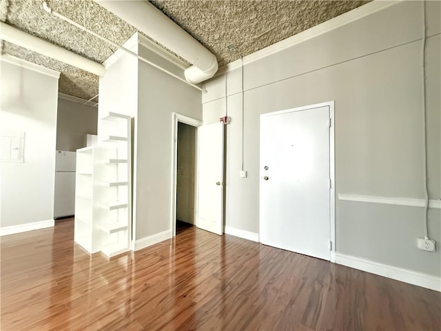 spare room with ornamental molding and hardwood / wood-style floors