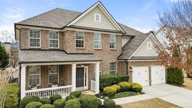 view of front of home with covered porch and a garage