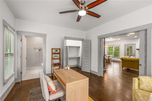office featuring baseboards, ceiling fan, and dark wood-type flooring