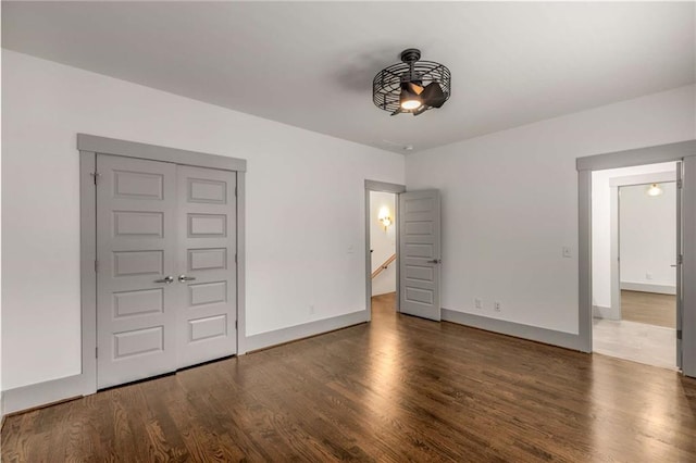 interior space featuring baseboards and wood finished floors