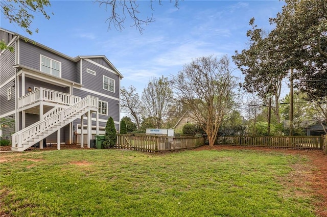 view of yard with stairs, fence, and a wooden deck