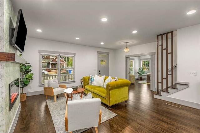 living room with a fireplace, wood finished floors, recessed lighting, and plenty of natural light