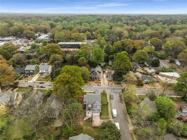 bird's eye view featuring a wooded view and a residential view