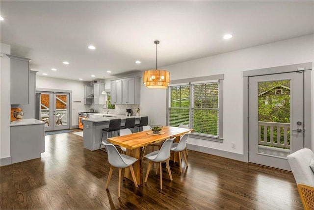 dining room with dark wood finished floors, baseboards, and recessed lighting