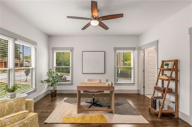 office area featuring dark wood-type flooring, a wealth of natural light, and a ceiling fan