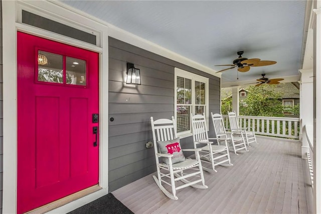 wooden deck featuring a porch and ceiling fan