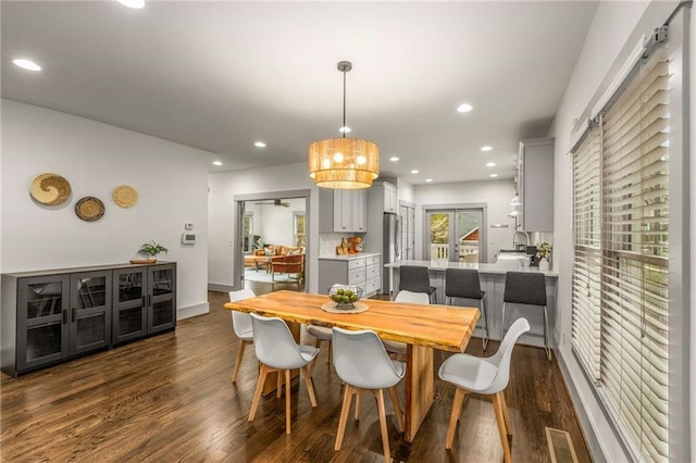 dining area featuring dark wood-type flooring, baseboards, visible vents, and recessed lighting