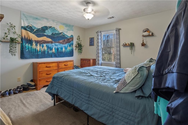 carpeted bedroom with a textured ceiling and visible vents